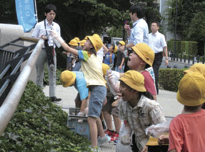 Aiai Bridge: Fujimidai Elementary School children are throwing EM Bokashi fermented Mudballs in the stream of the river