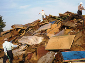 September 22, 2015. Ishige district of Joso City, EM spraying project at garbage collection site, which is piled high with furniture, tatami mats and other objects that were swept away by the flood